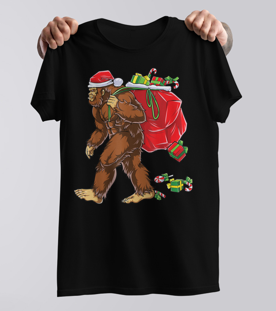 Bigfoot Santa With Giant Red Christmas Bag And Green Gifts Wearing Xmas Hat T-Shirt