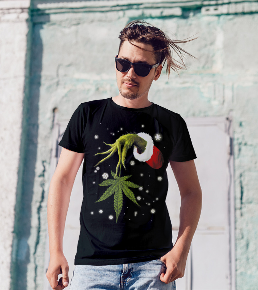 Grinch Hand Holding Cannabis Leaf With Santa Hat And Snowflakes T-Shirt