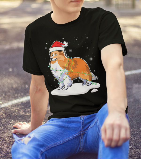 Sheltie Dog Santa Wrapped In Christmas Lights On Snowy Night T-Shirt