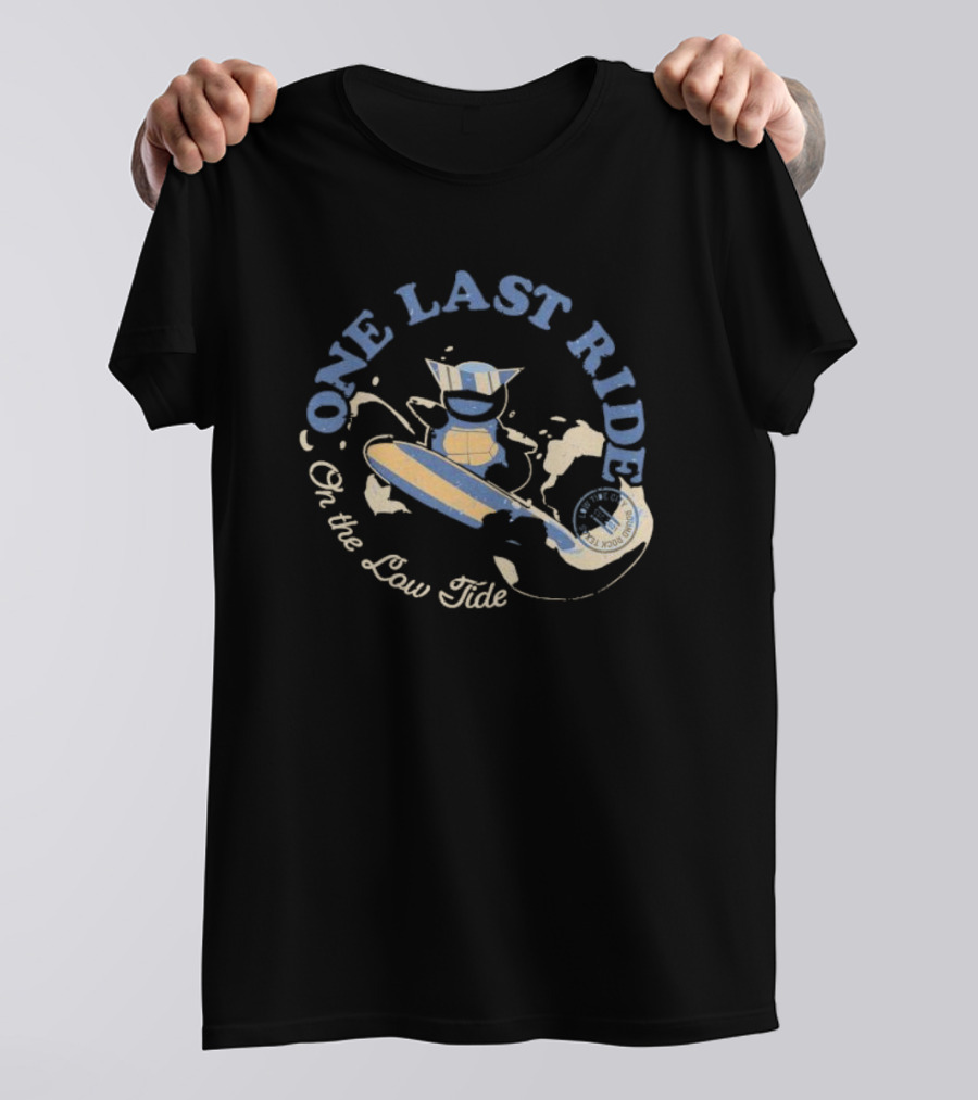 Surfing Adventure With Blue Masked Figure And Iconic Board 'One Last Ride On The Low Tide' T-Shirt