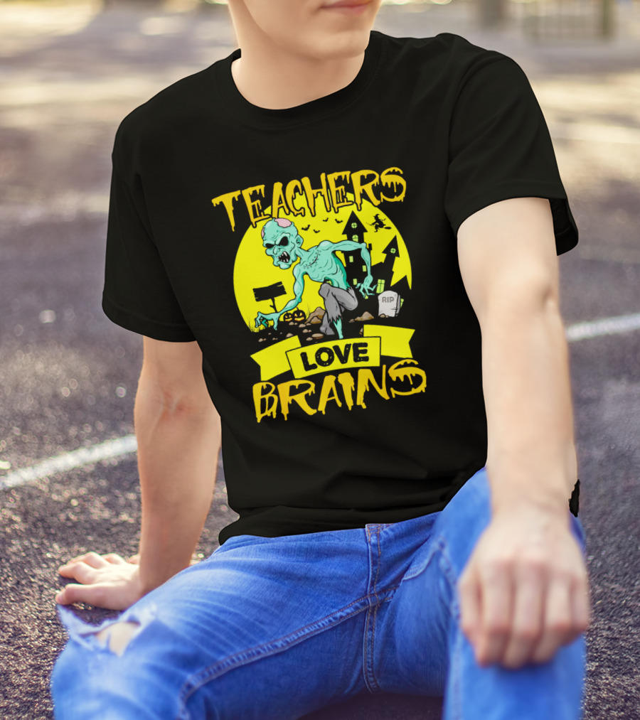 Teachers Love Brains Zombie Halloween Theme With Haunted Houses And Graveyard Background T-Shirt