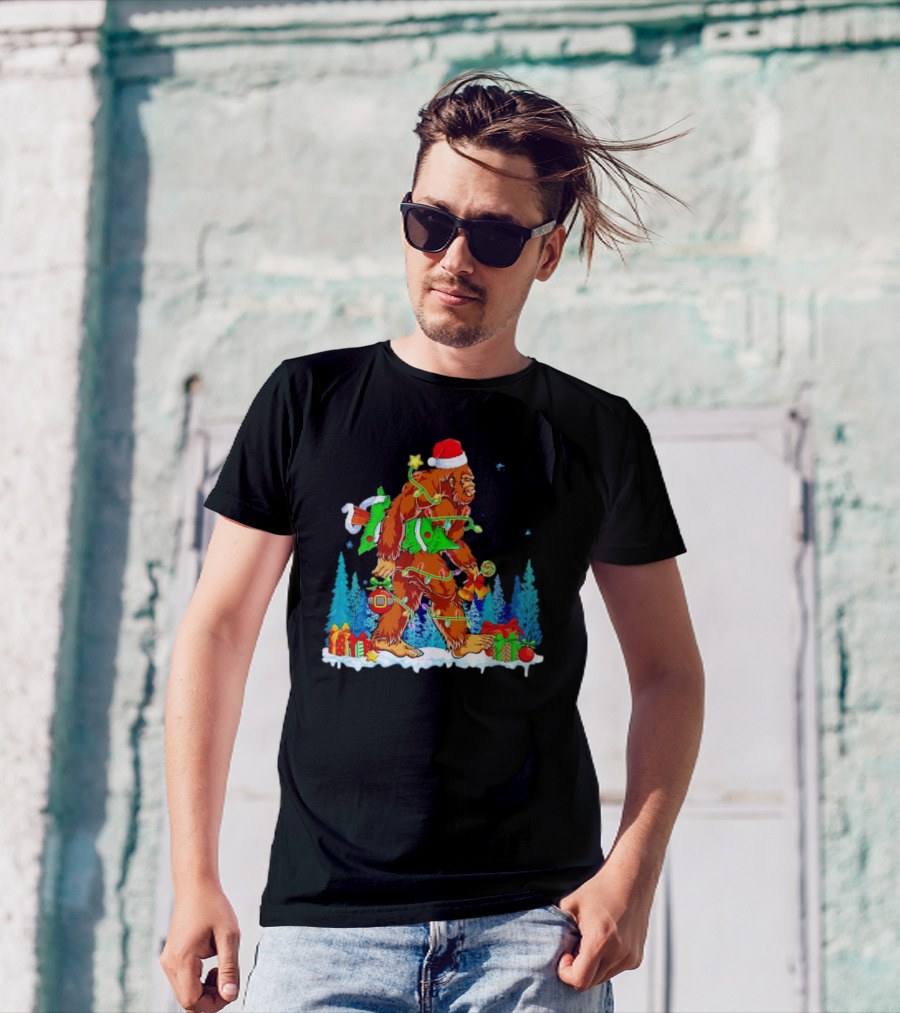 Bigfoot Santa Hugging Christmas Tree With Gifts And Snow Scene T-Shirt